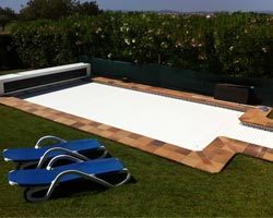 Box slatted pool deck in garden with hammocks