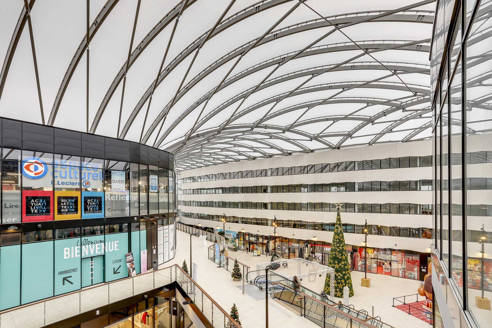 Transparent ETFE cushions with cloudy skies.