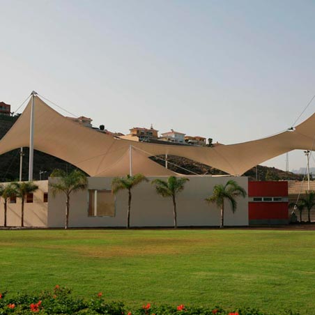 Estructura tensada irregular en jardín de espacio urbano