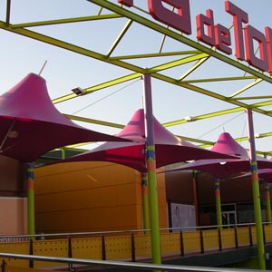 Estructura tensada en forma de parasol de color rojo en centro comercial Puerta toledo